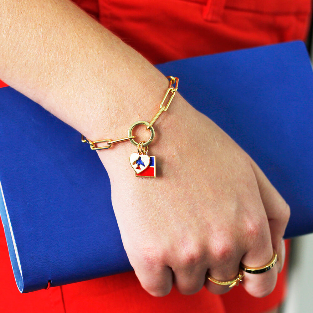 Gold link bracelet, the daily 360 featuring a heart airplane charm and nautical letter charm, by Jet Set Candy.