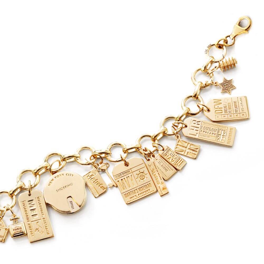 Solid Gold Infinity Link Travel Charm Bracelet featuring a variety of solid gold travel charms including charms for New York City, Martha's Vineyard, Dallas, London, Paris, U.A.E., Delhi, and Melbourne