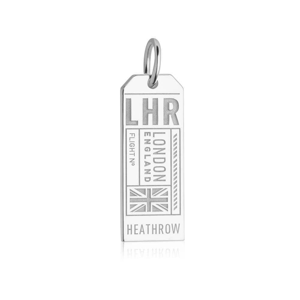 Silver London England LHR Luggage Tag Charm from  JET SET CANDY on a white background. The charm includes engravings of LHR and London England as well as "Heathrow" and a Union Jack icon