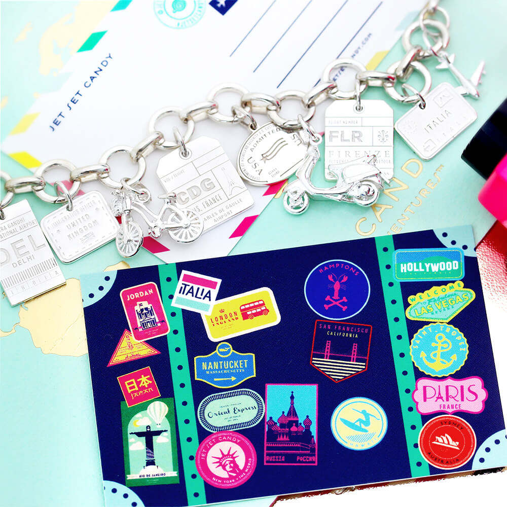 Sterling Silver charm bracelet featuring travel motifs including a Vespa, bicycle, airplane, and luggage tags with CDG and FLR engravings.