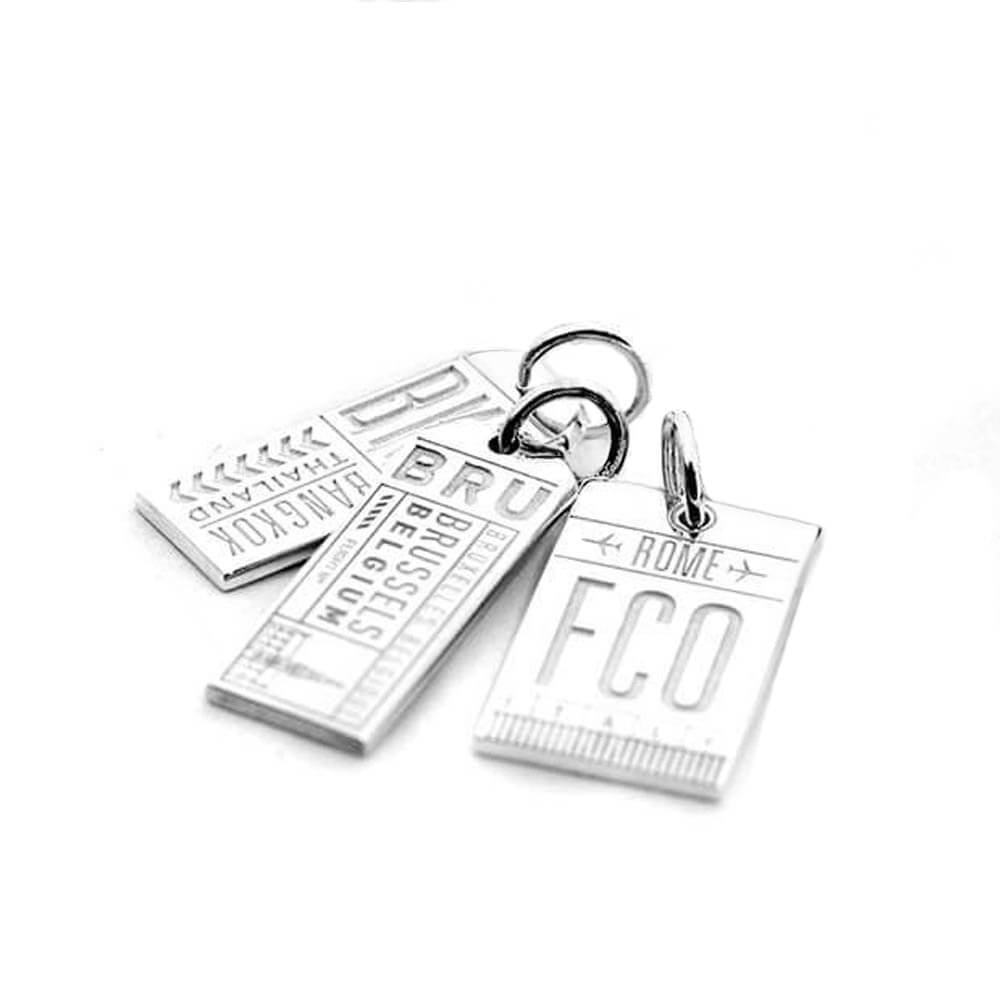 Bundle of three sterling silver luggage tag charms from Jet Set Candy, featuring various travel-inspired designs on a white background.