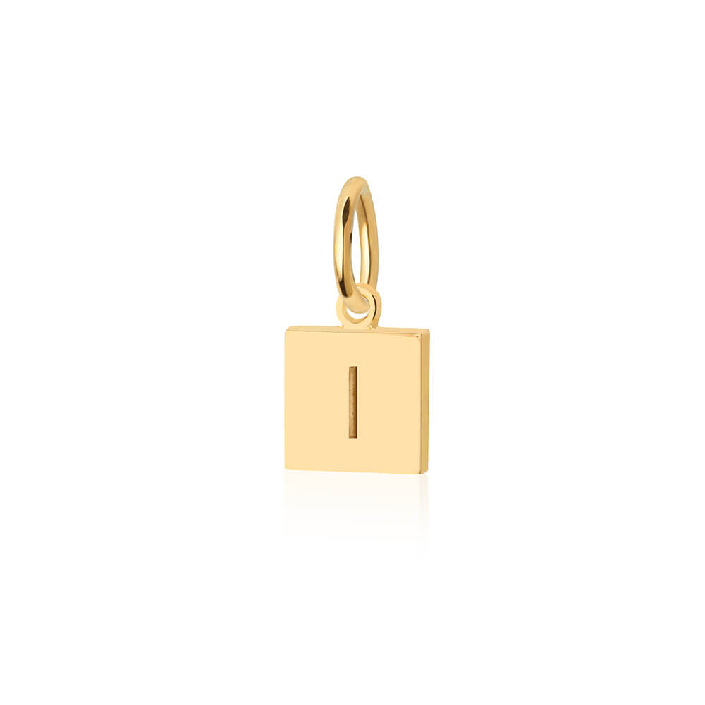 Gold charm featuring a square luggage tag shape with a polished finish and a vertical line engraving motif.