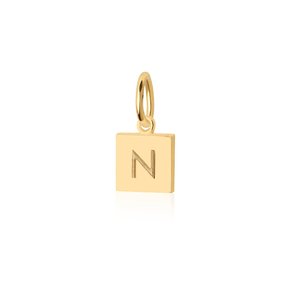 Gold Charm featuring a square tag design with a minimalist engraved letter N and a polished bail attachment.