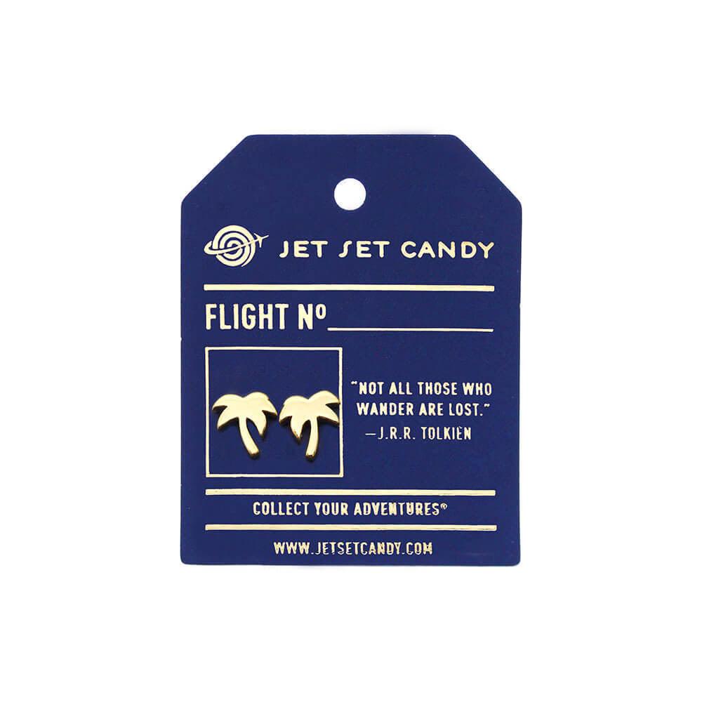 Gold palm tree stud earrings displayed on a blue Jet Set Candy card featuring a J.R.R. Tolkien quote.