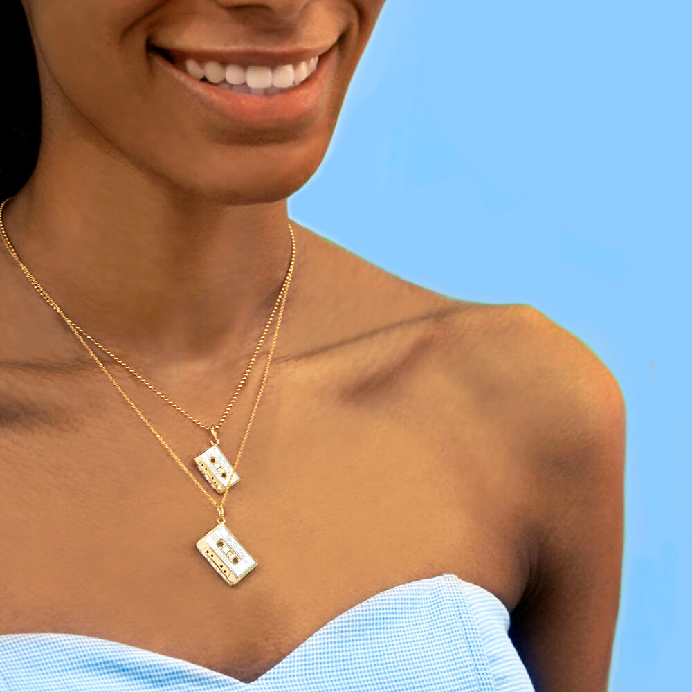 Gold cassette tape necklaces by Jet Set Candy, shown in small and large sizes on a white background.