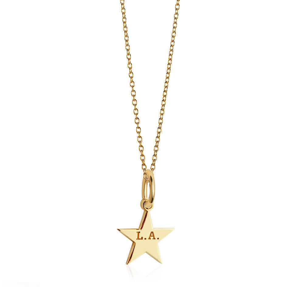 Gold star charm featuring L.A. engraving suspended from a delicate matching cable chain, showcasing a polished finish and minimalist design.