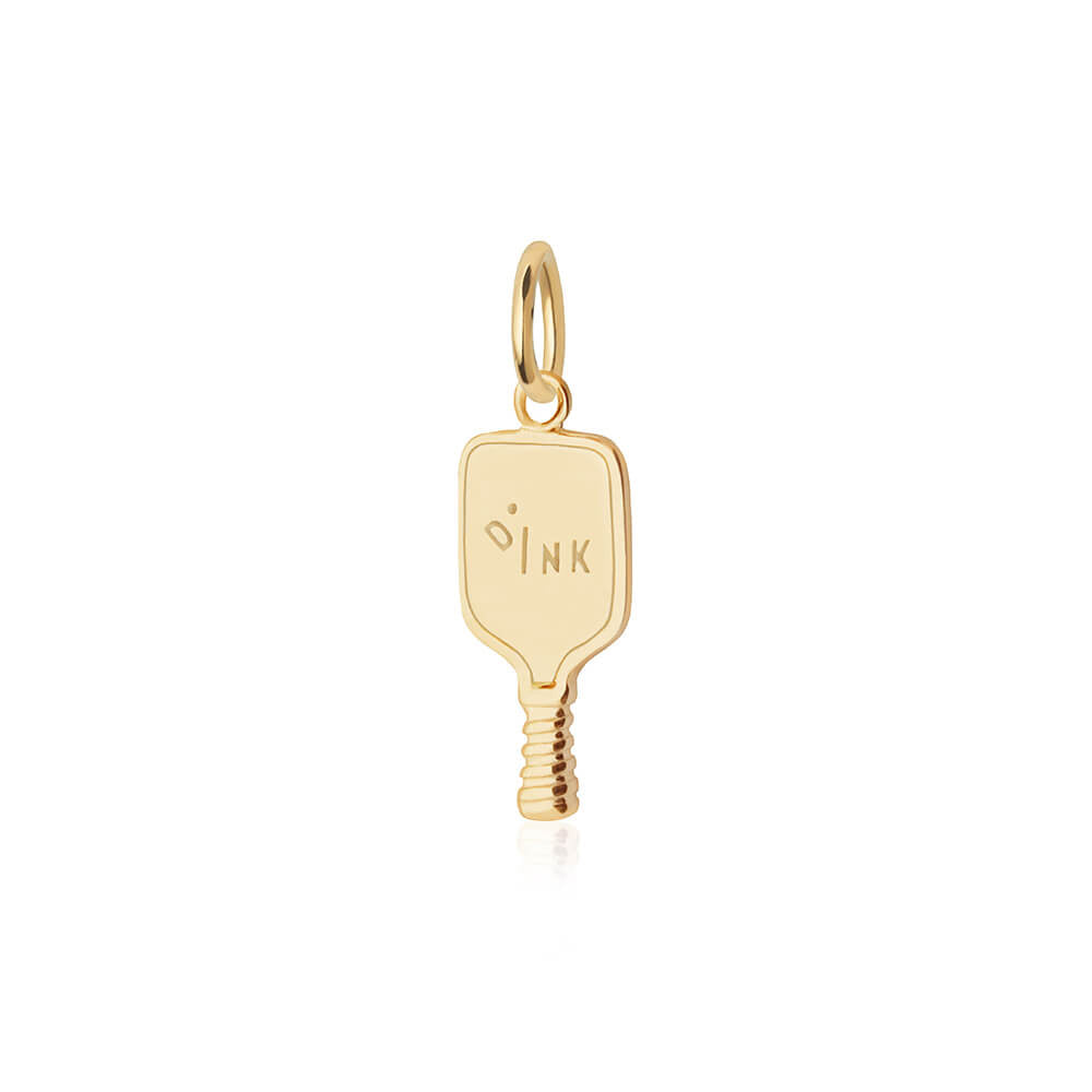Gold charm in the shape of a pickleball paddle featuring an engraved DINK text motif and ribbed handle.