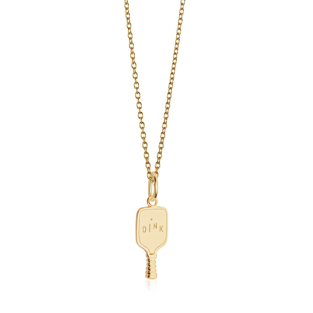 Gold charm shaped like a pickleball paddle with DINK engraving and a small ball motif on a matching chain.