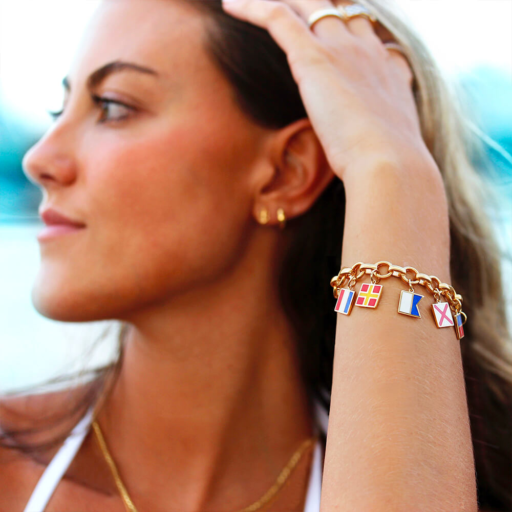 Gold Enamel Charm bracelet featuring colorful nautical maritime signal flag motifs including rectangular and square pendants on a chain.