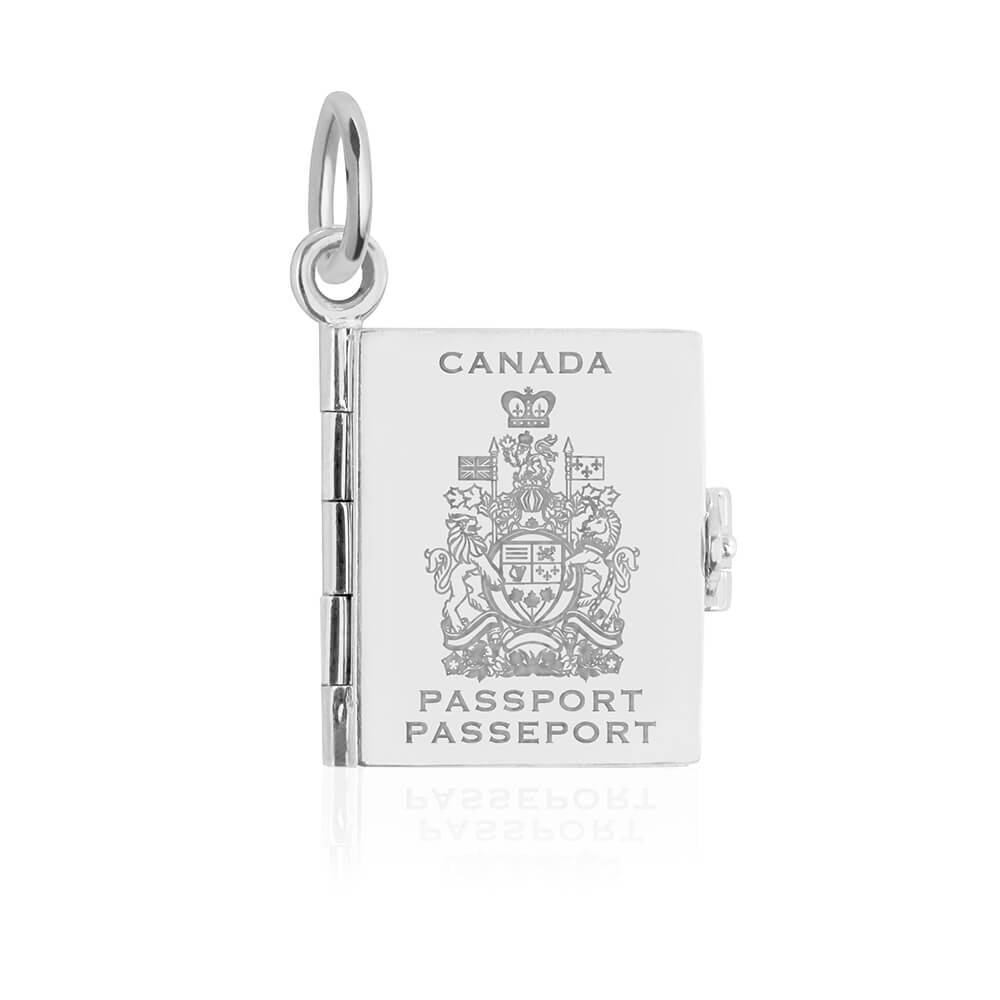 Silver Canada passport book charm by Jet Set Candy, with engraved cover details and travel elements on a white background.