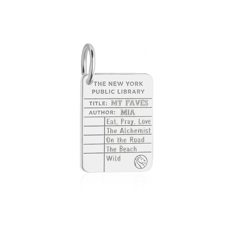 Sterling Silver charm shaped like a New York Public Library card featuring engraved book titles and a lion logo.