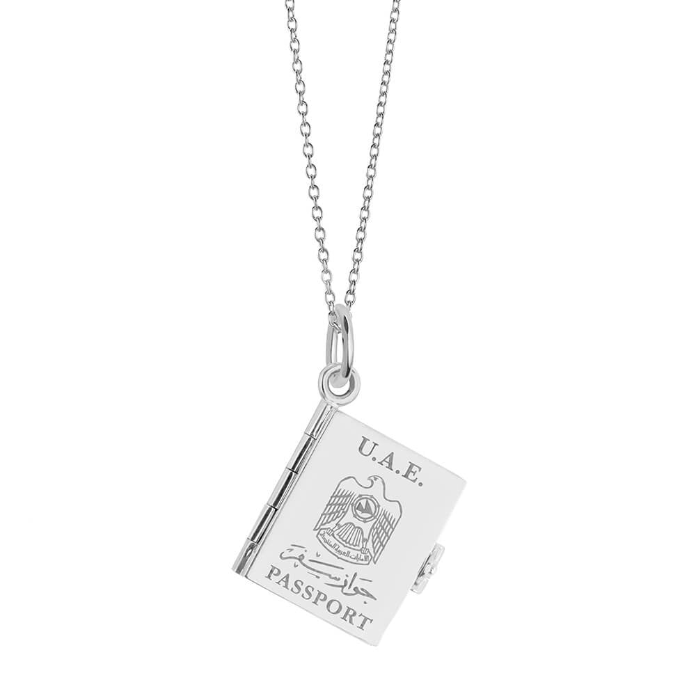 Silver UAE passport book necklace by Jet Set Candy, featuring a travel-themed charm on a white background.