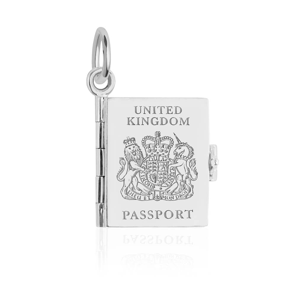 Silver UK passport book charm by Jet Set Candy, featuring engraved details on a white background.