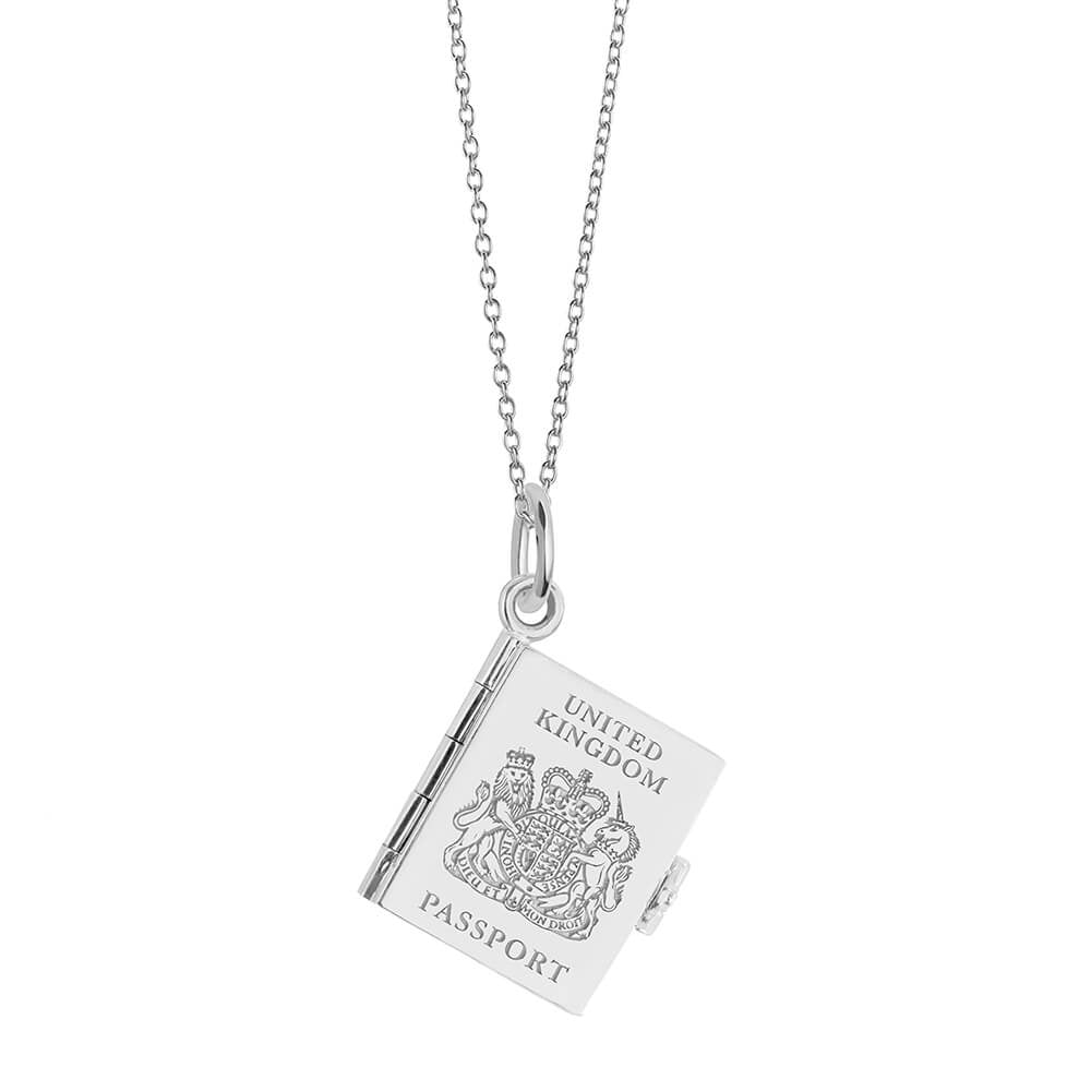 Silver UK passport book necklace by Jet Set Candy, featuring an engraved charm on a white background.