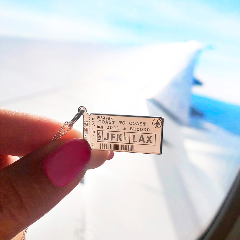 Sterling Silver boarding pass charm featuring JFK to LAX engraving, airplane icon, barcode detail, and Jet Set Air text.