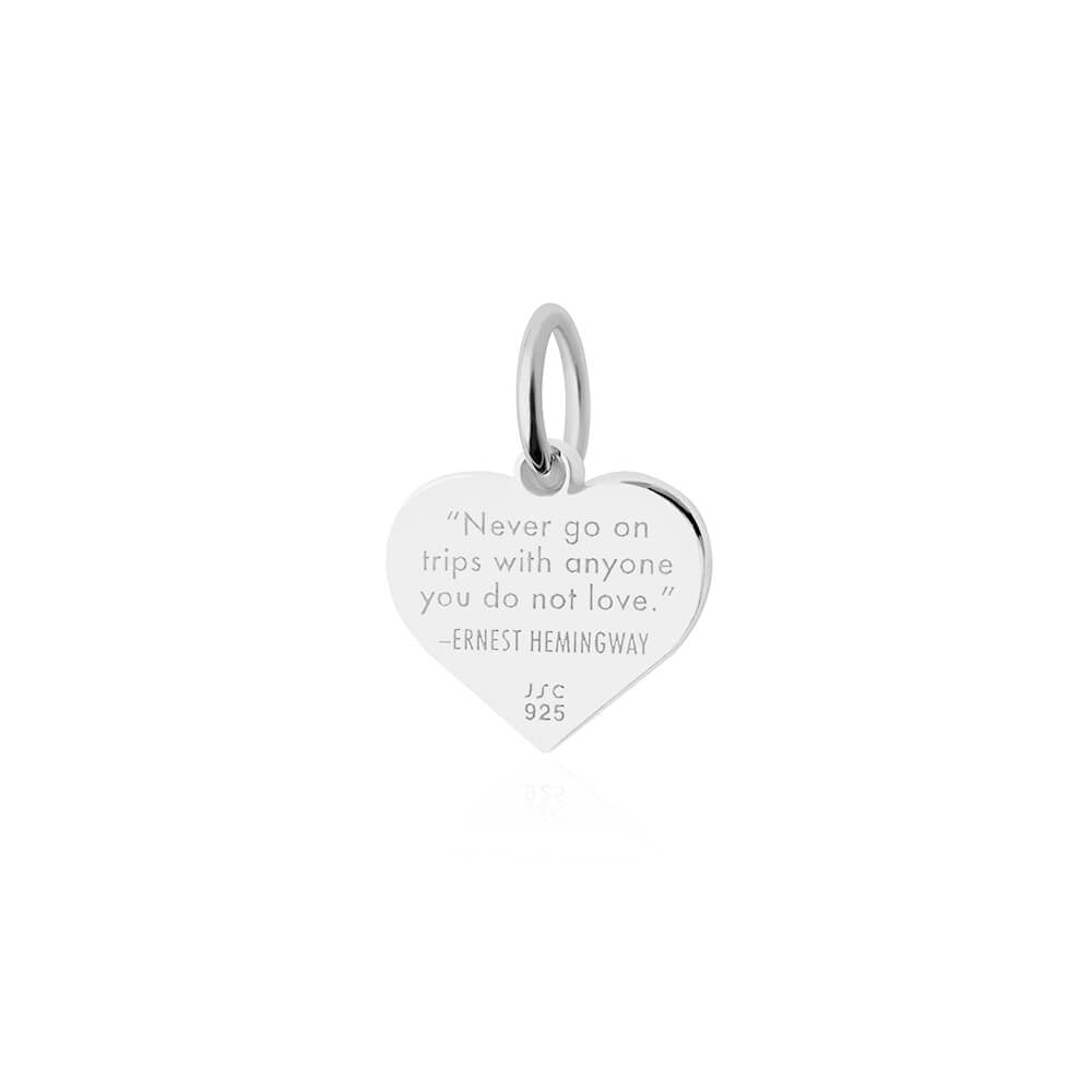 Sterling Silver heart charm featuring an engraved Ernest Hemingway quote about travel, including a polished finish and jump ring.