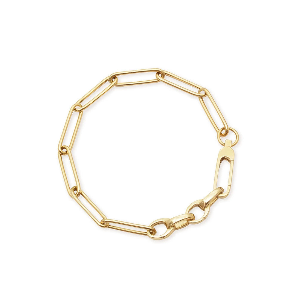 Gold paperclip link chain bracelet featuring elongated oval links, a lobster clasp closure, and polished finish for charms.