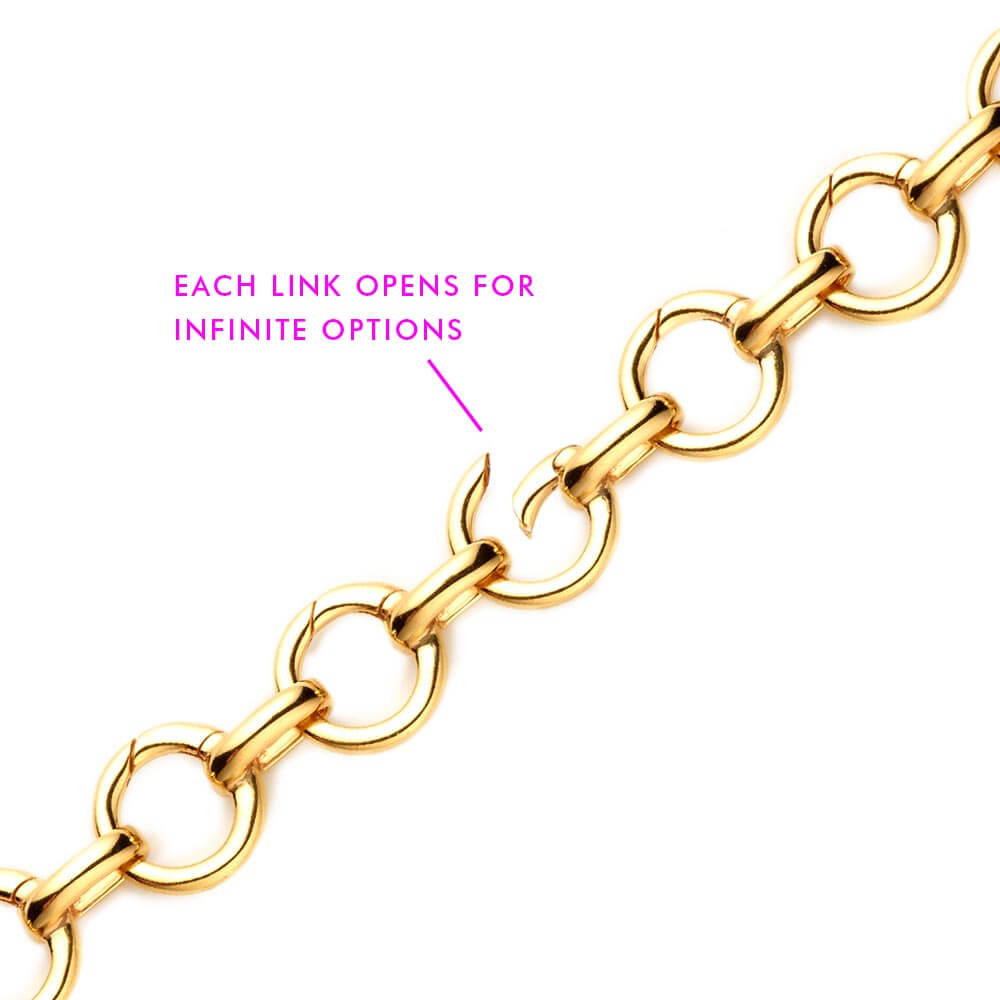 Gold Infinity Link Charm Bracelet from  JET SET CANDY showing that each clasp opens via a spring hinge. The image is annotated with a call out in pink letters that says 