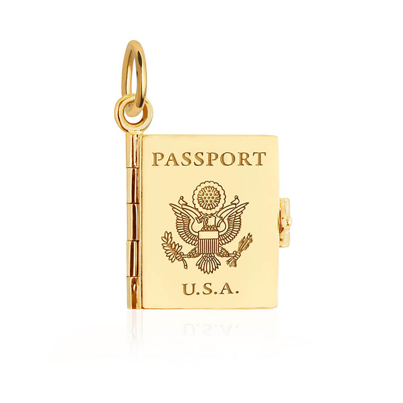 Bespoke Solid 14k Gold USA Passport Book Charm shown on a white background. This charm is fully customizable and you can choose up to 12 passport stamps to include on the solid gold pages inside.  Inspired by actual entry and exit stamps for over 200 countries and territories around the globe, this charm is a one-of-a-kind souvenir. For the finishing touch, add a personalized message or your initials and a date on the back.  