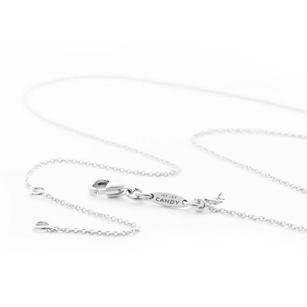 Sterling Silver charm necklace featuring a lobster clasp, delicate cable chain, and an oval tag engraved with JET SET CANDY.