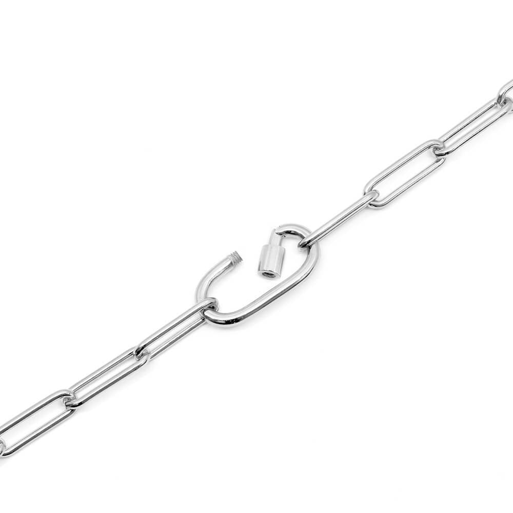 Photo featuring the Daily Charm Necklace in sterling silver from Jet Set Candy. The necklace  features long rectangular links with rounded corners and an inch-long carabiner that is shown open and allows for charms to be added. The chain necklace is shown on a diagonal on a white background.