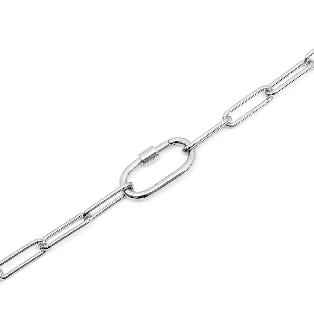 Photo featuring the Daily Charm Necklace in sterling silver from Jet Set Candy. The necklace features long rectangular links with rounded corners and an inch-long carabiner that is shown closed and allows for charms to be added. The necklace is shown on a diagonal on a white background.